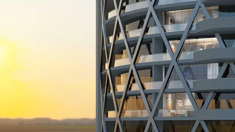 Diagonal structural bracing across a contemporary tower façade at sunset
